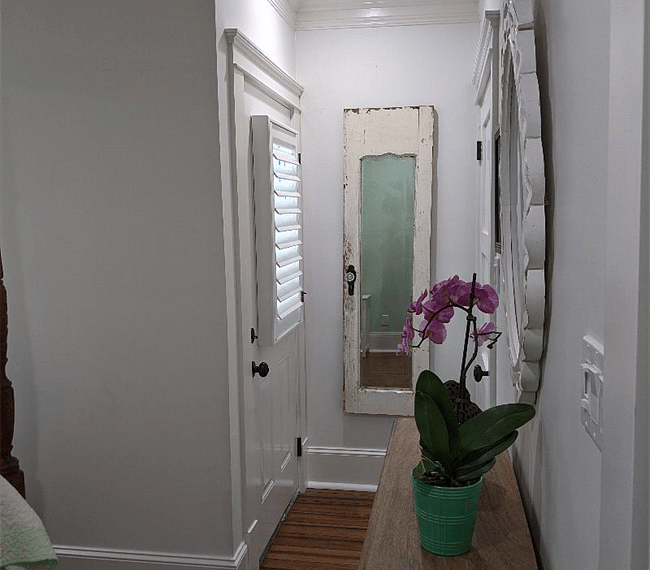 Door to the left of the mirror goes to a small back patio. The closet door is to the right of the mirror. Other than extra bedding, the closet is empty for you.