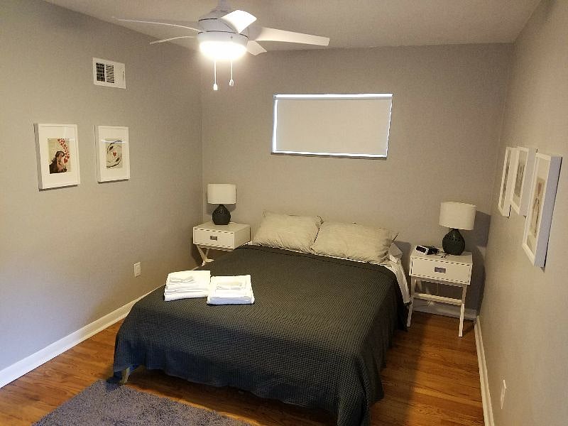 Bedroom #1 - queen innerspring mattress, ceiling fan, and blackout shades