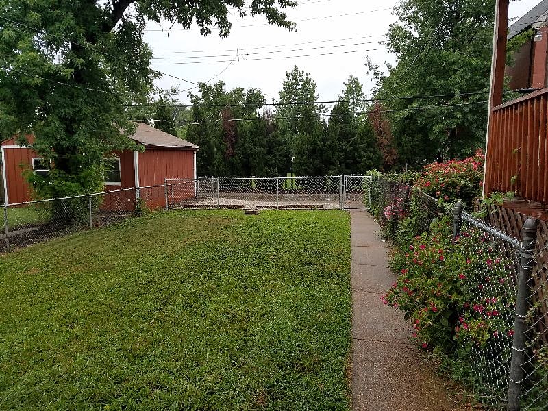 Backyard, parking area behind fence