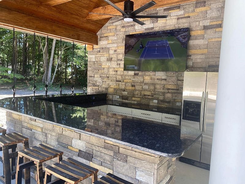 Pool cabana with cable tv, fridge, and fan. Great for watching tv by the pool.