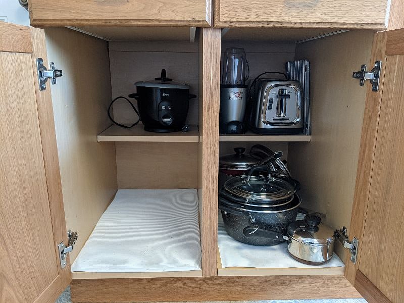 Array of pots/pans, rice cooker, magic bullet for smoothies and grinding coffee, toaster and plenty of room for your pantry.