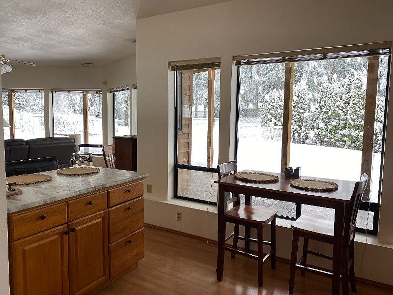 Kitchen has Large Picture Windows for Nice Lighting, with an Island and Table to Accommodate Your Guests