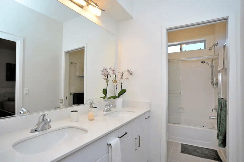 Bathroom has two sinks with quartz counter top.