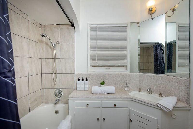 A shower and bath combo features in the bathroom