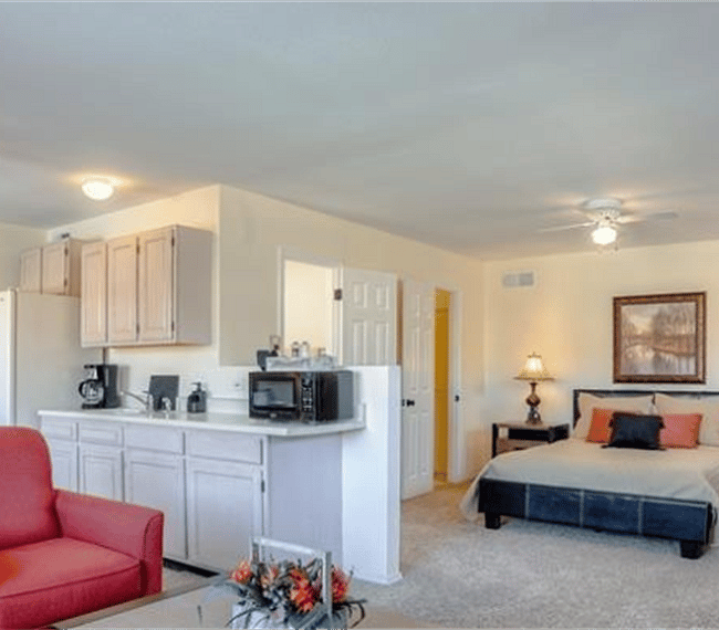 View from living room to bed and kitchen