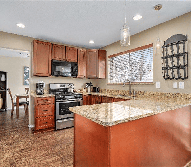 Spacious & bright fully stocked kitchen offers attractive granite counters and new appliances.