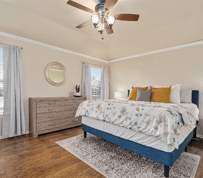 Luxury hardwood floors in the large primary bedroom features King size bed and plenty of dresser/storage space. In addition, enjoy a 50 inch television and convenient desk if working from home is necessary.