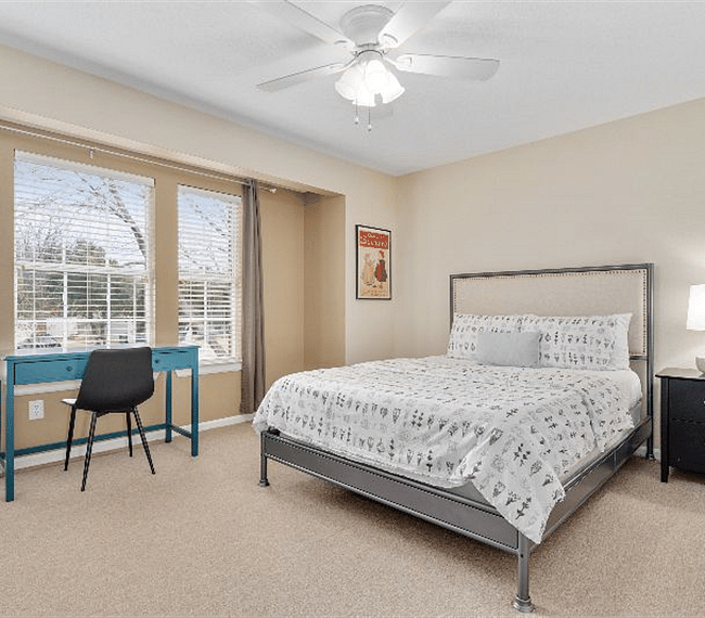 Guest Bedroom 1 is complete with queen size bed, dresser, 40 inch smart TV and desk for work or study.