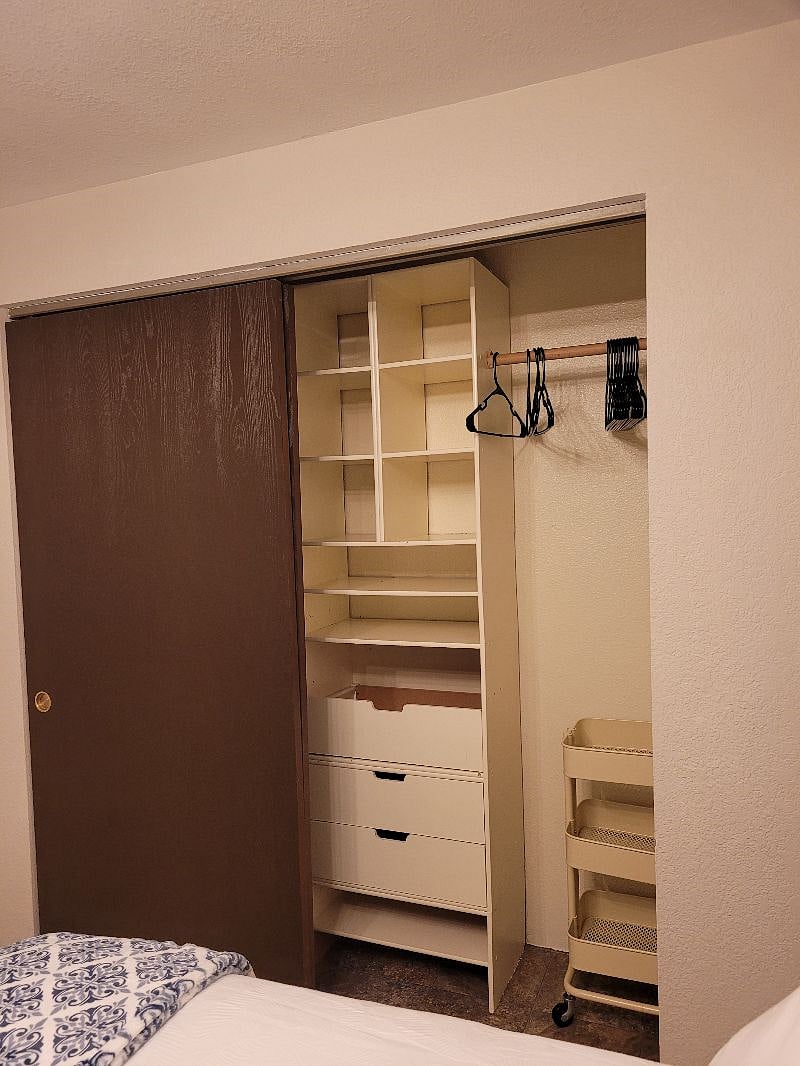 Right side of bedroom closet, drawers & shelves