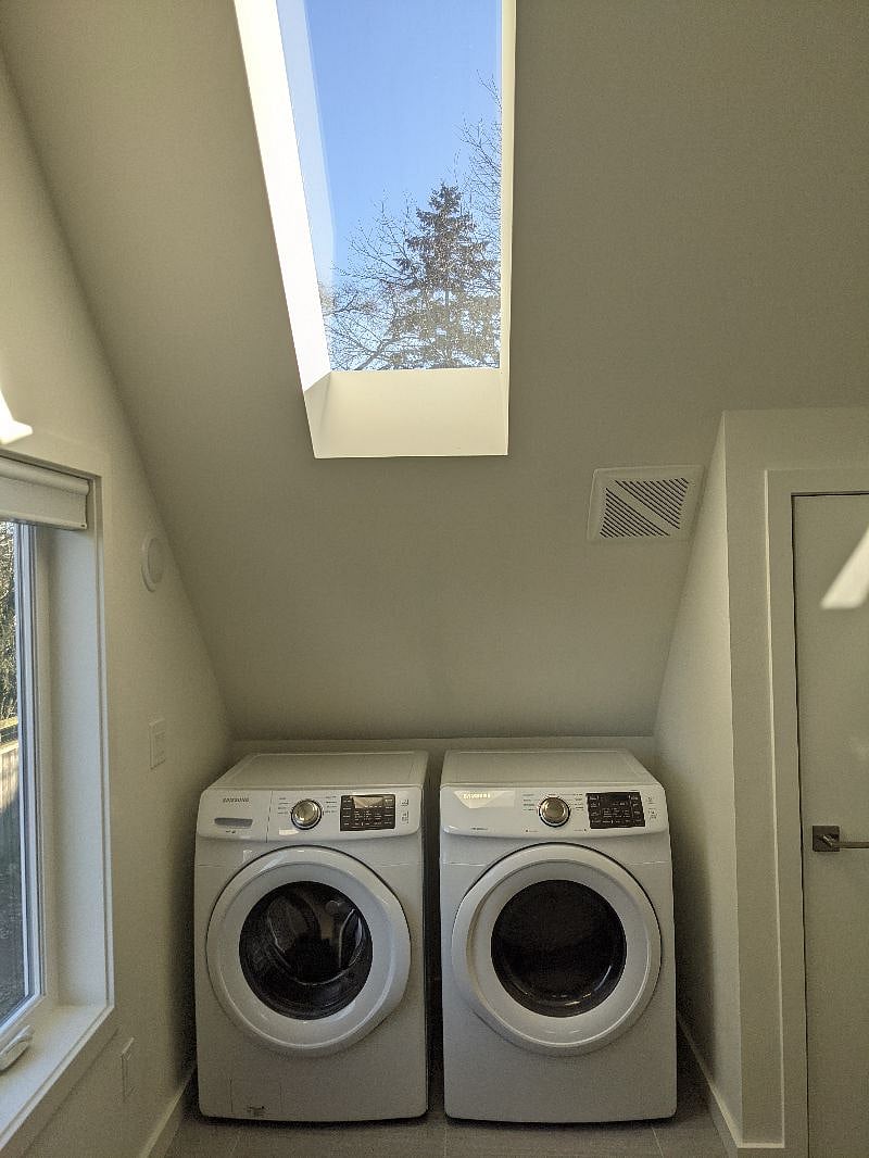 Full Size Washer and Dryer hidden behind curtians