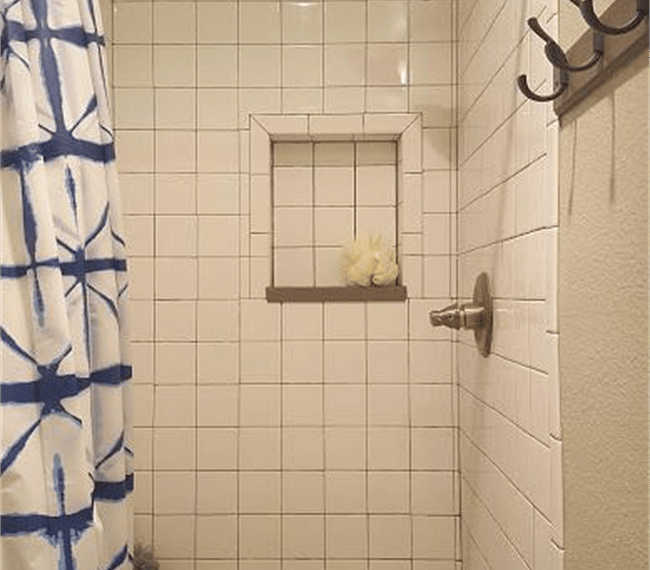 An ample shower features in the bathroom