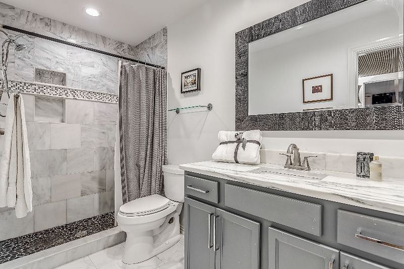 The bathroom is modern and stylish with shower, toilet and vanity
