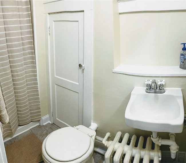 Bathroom with cute little linen closet to hold the essentials.