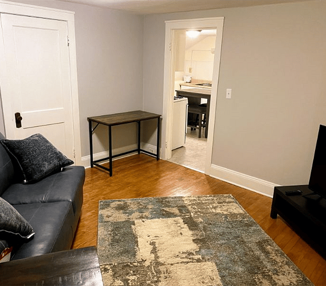 Living Room - View looking toward kitchen 
(With laptop desk and 50" TV)