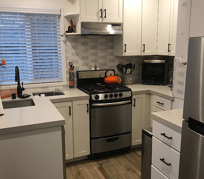 Kitchen with refrigerator, stove, microwave, dishwasher and garbage disposal. All kitchen necessities provided.