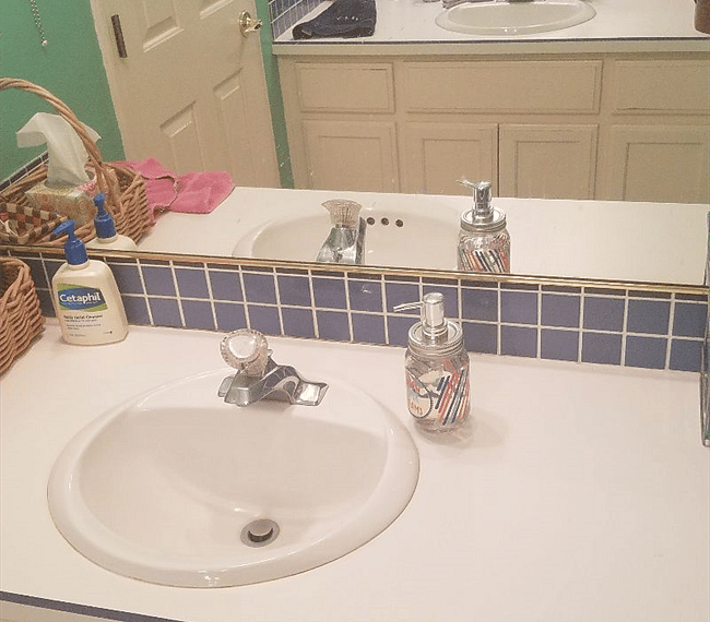 Bathroom has 2 sinks with vanities and cabinets on opposite walls.
