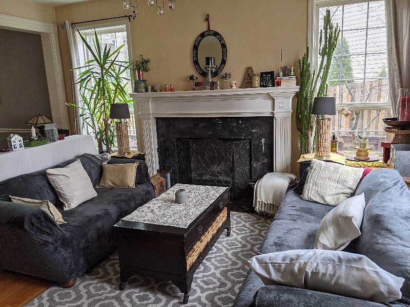 Living room with wood burning fireplace.
