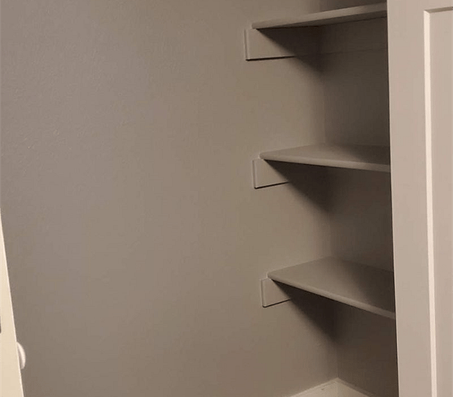 Spacious bedroom closet with shelves