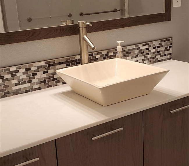 Full bathroom with vanity sink, tiled backsplash and large mirror