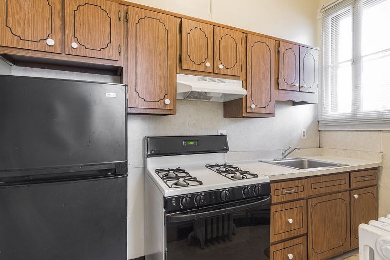Kitchen with refrigerator and range