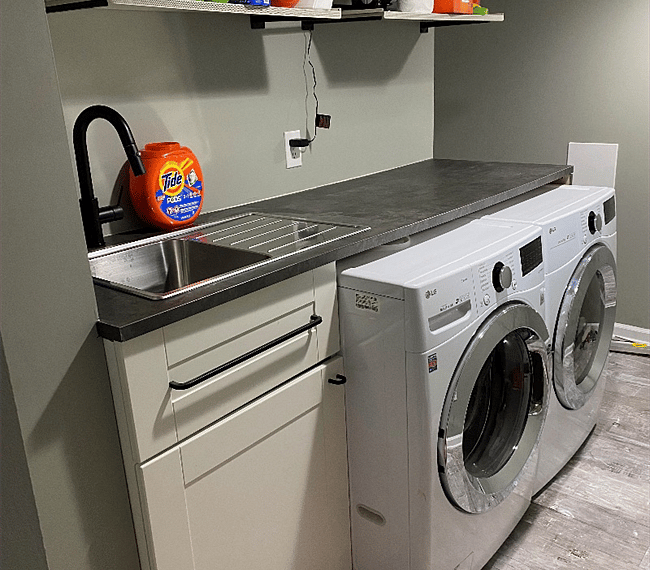 The new laundry is in the adjacent part of the basement. You can lock and bolt the door in between.