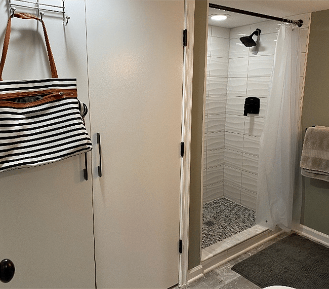 The closet in the bathroom is huge, with wire shelves and drawers inside, and space to hang clothes.
