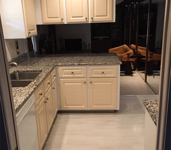 Kitchen looks into den.