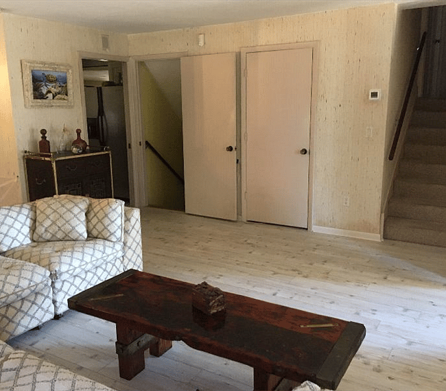 Living room. Stairs on left go down to the laundry room. Stairs on right go up to bed and bath rooms.