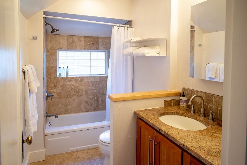 Bathroom with tub and shower is on the main level.