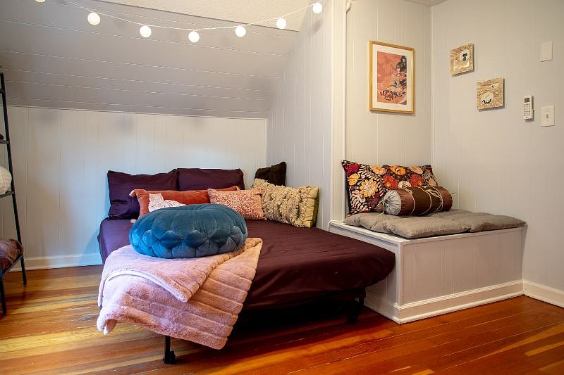 The futon bed is filled with comfy pillow for a great reading nook or nap space.