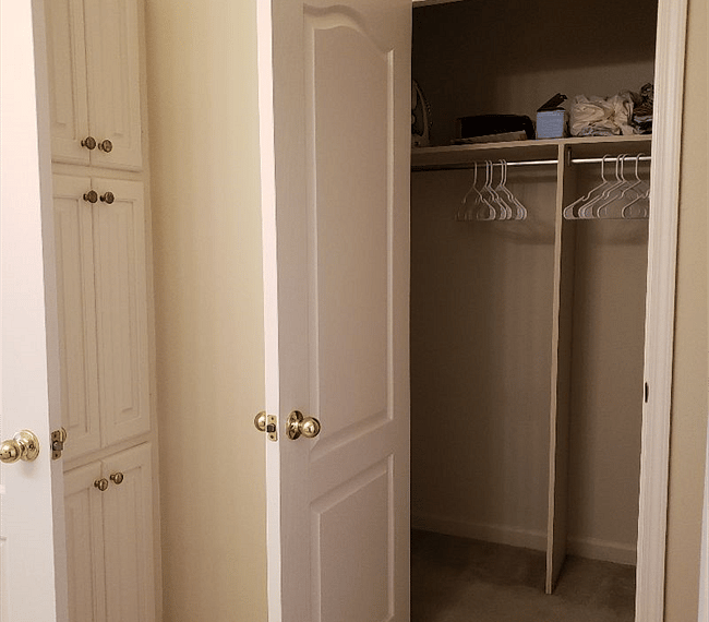 Master bathroom walk in closet and storage cabinet. Iron and ironing board, extra linens and blow up twin mattress and pump located in this closet.
