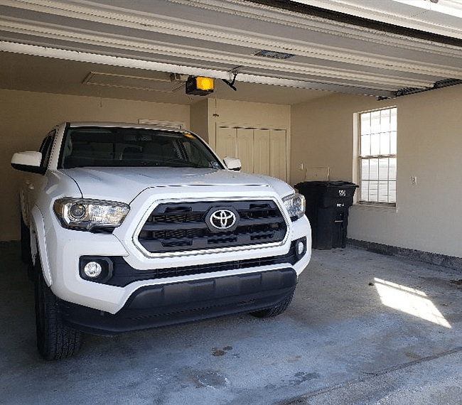 Enclosed garage with washer and dryer. Toyota Tacoma for scale.
