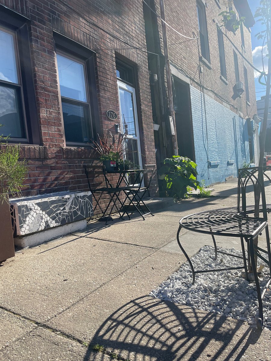 Lots of seating out front plus a flowering tree added - great for summer evening gatherings