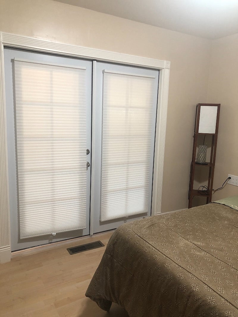 French door separates the living room from the bedroom.