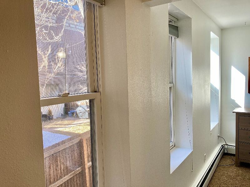 Huge windows with up/down blinds in master bedroom.