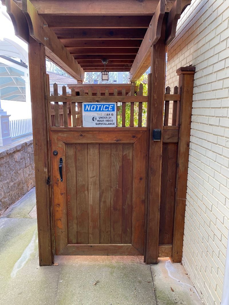 Locked gate into backyard and garage access. Camera on property entrance as well (not in carriage house).