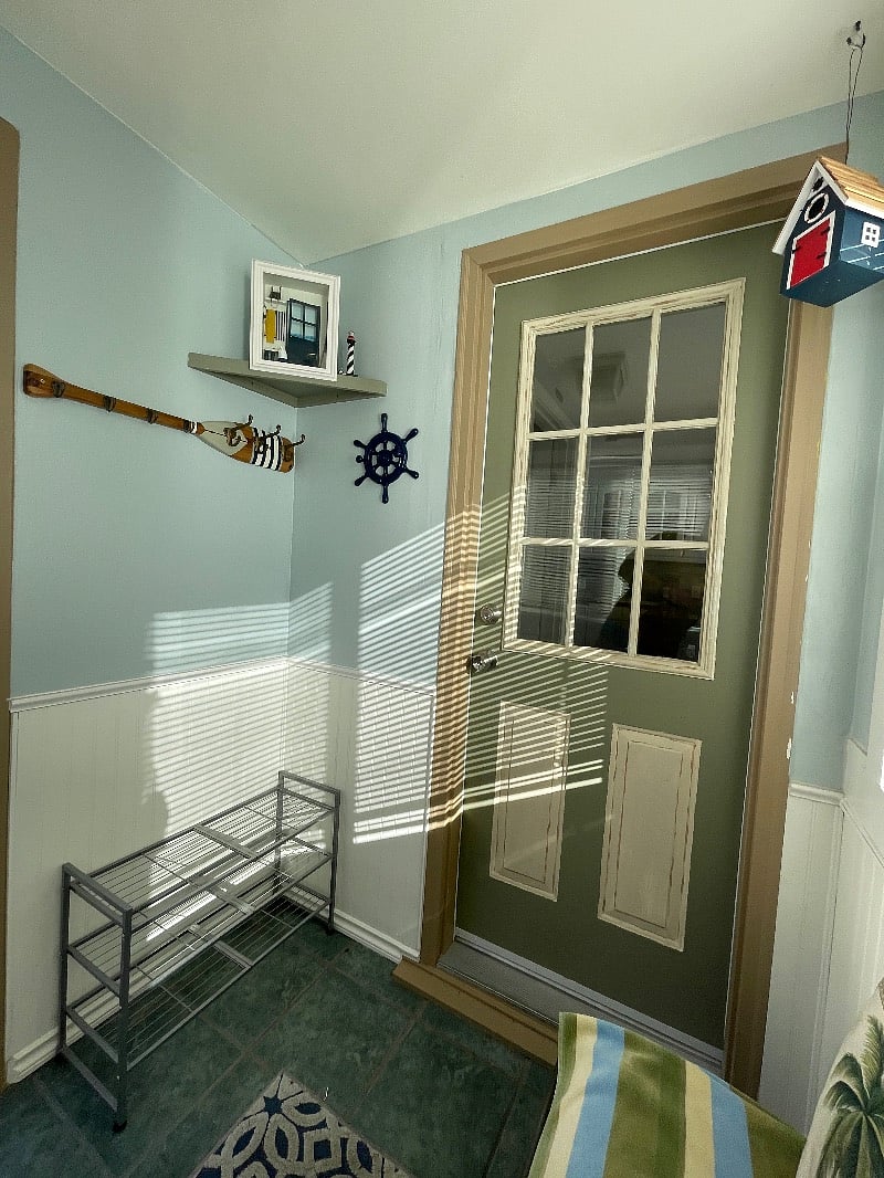Mudroom shoe storage rack, nautical coat hanger and entrance to house.