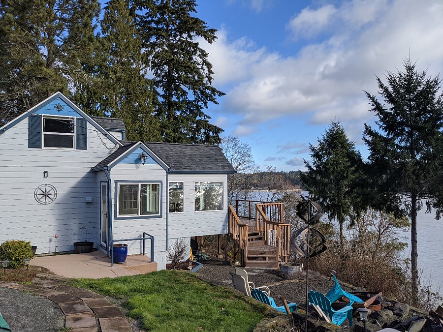 View of right side of home with mudroom entrance and upper floor office