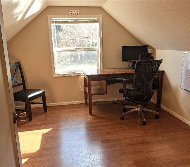 Upper Office with desk, book shelves and filing cabinet.