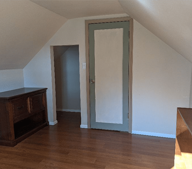 Upper Office with desk, bookshelves and filing cabinet.