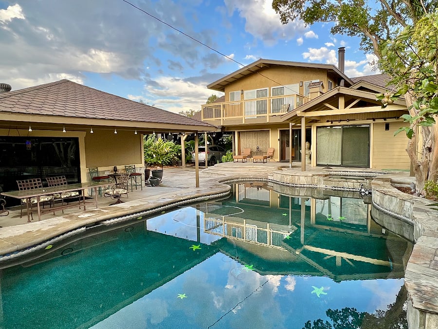 Backyard pool house has laundry and exercise equipment