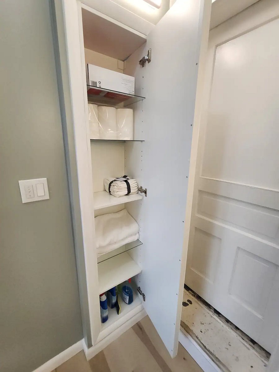 Built in linen closet with night lighting