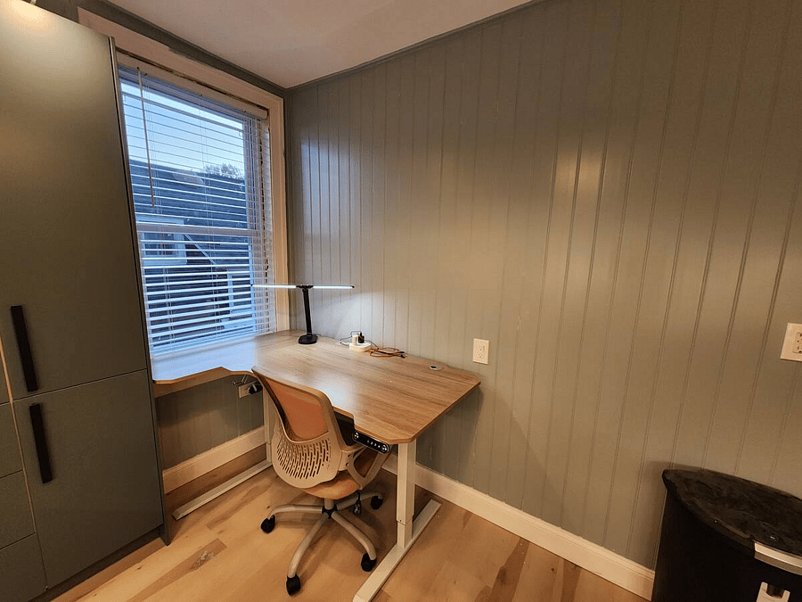 Home office workspace with beautiful natural light. L shaped motorized sit/stand desk with plenty of room to spread out if you need to work from home.