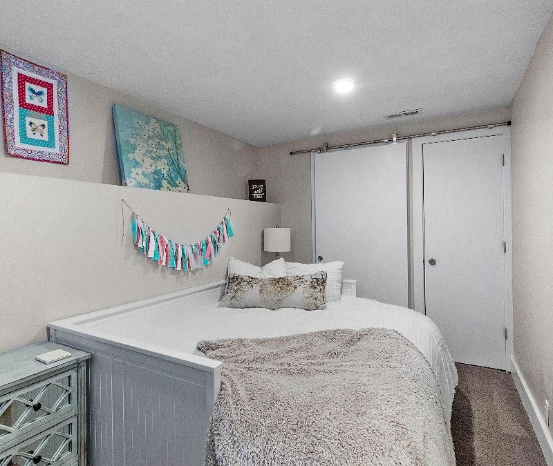 Basement bedroom with queen bed