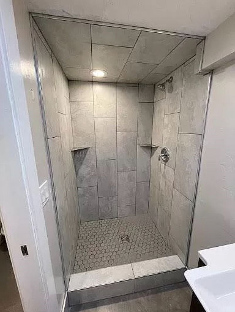 Large tile shower in the bathroom.