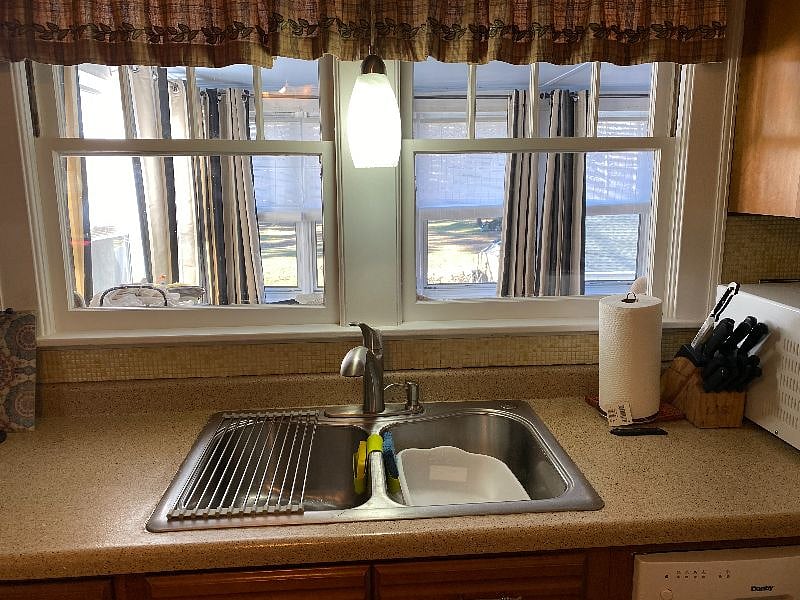 kitchen sink area over looks the rear three season porch and the property (nearly an acre of land).