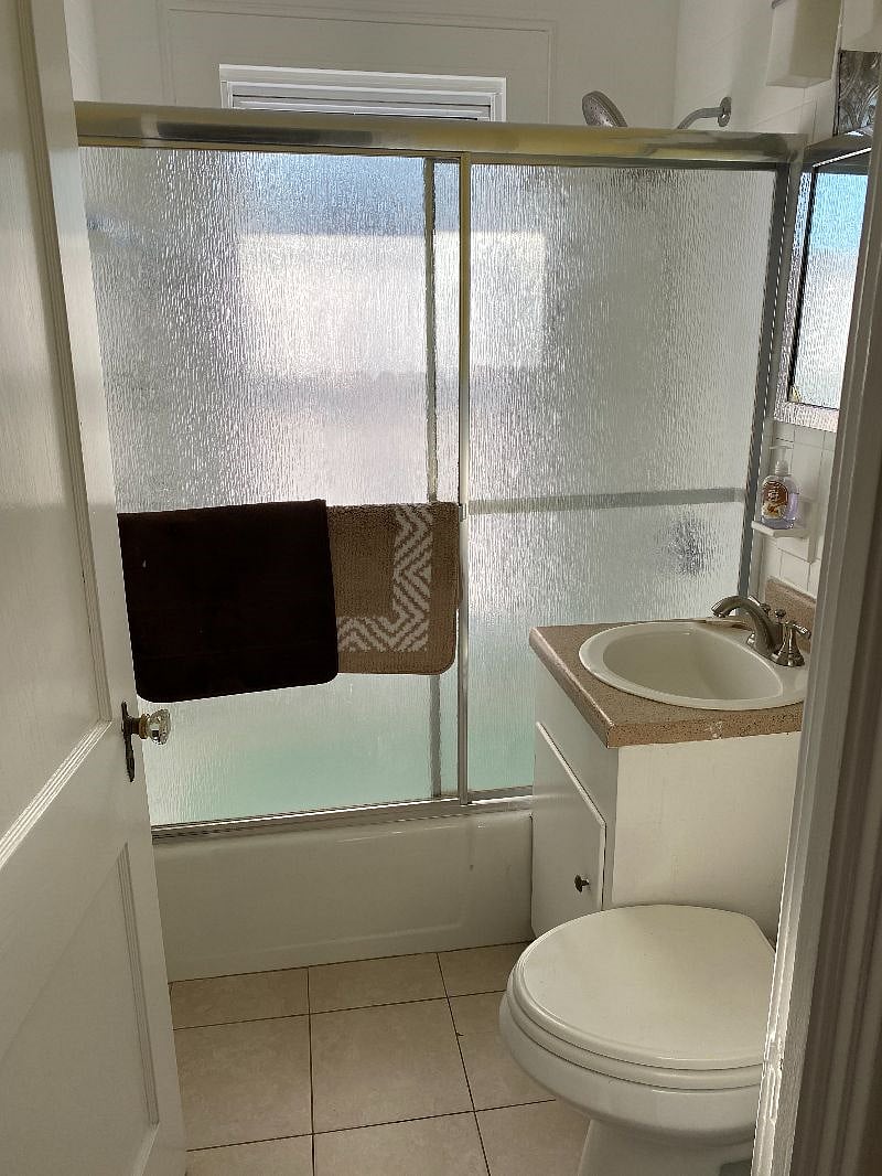 shared bathroom tub, shower, sink and toiler