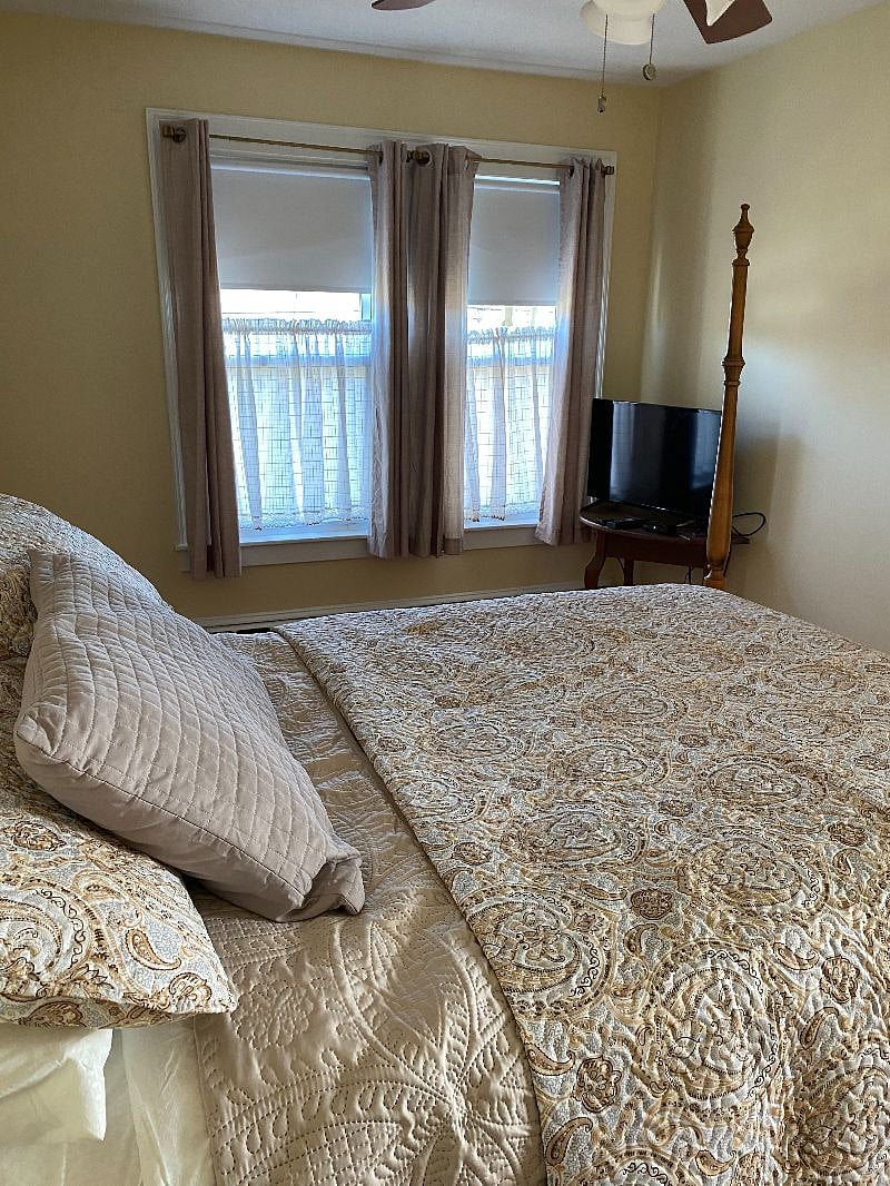 This is the medium sized bedroom. It has an in bedroom closet and two dressers.  This photo is not current as to the two dressers.  Ceiling fan in this room