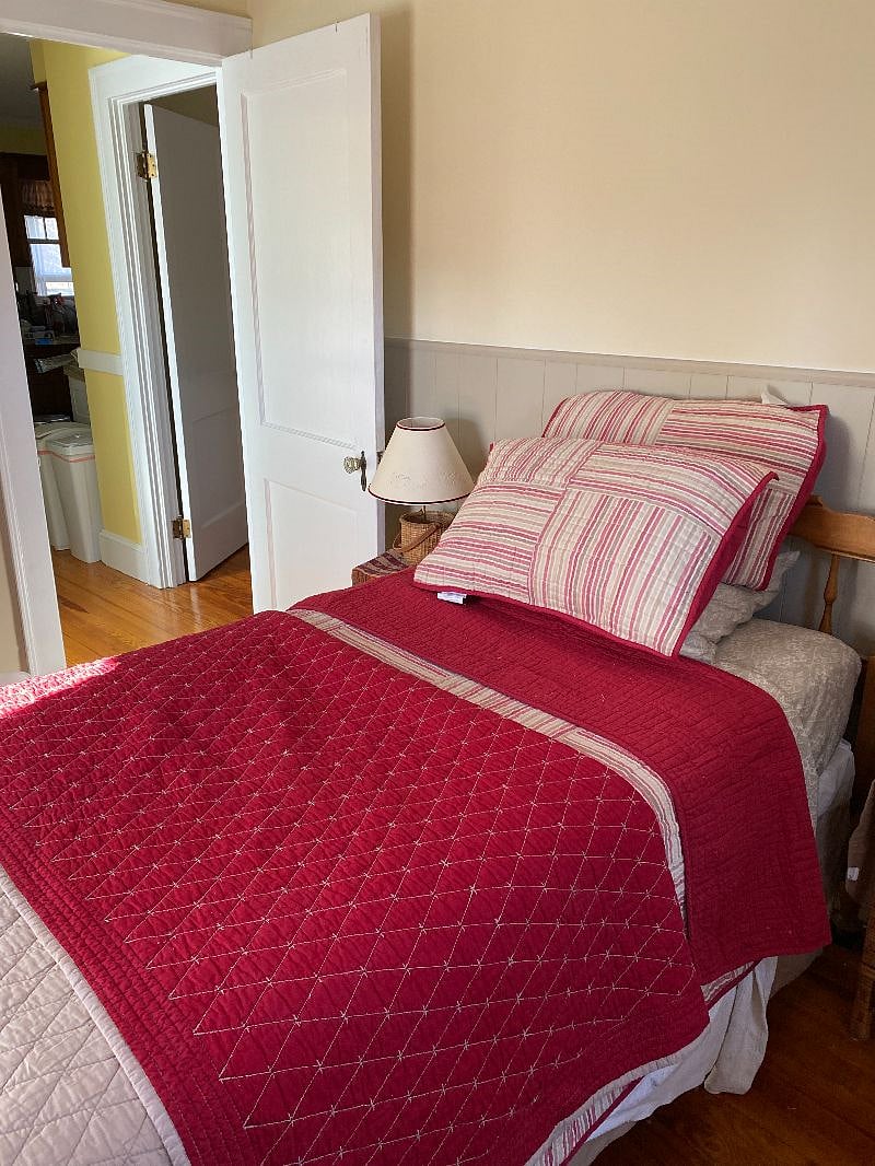 Smallest bedroom, twin sized bed,  located off kitchen and shared bathroom next to medium sized bedroom.  Current coordinates are blue and tan.  I typically do not rent this room unless there is a family or group together who require it. Ceiling fan in this roomth