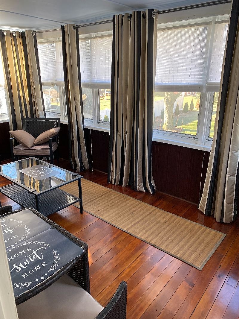 three season porch with seating and ceiling fan